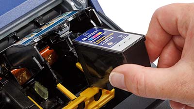 En person som laddar en bläckpatron.