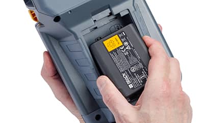 En person som installerar ett batteri med hög kapacitet i en Brady M510-skrivare